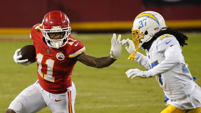 Jan 3, 2021; Kansas City, Missouri, USA; Kansas City Chiefs wide receiver Demarcus Robinson (11) runs the ball against Los Angeles Chargers cornerback Tevaughn Campbell (37) during the second half at Arrowhead Stadium. Mandatory Credit: Jay Biggerstaff-USA TODAY Sports